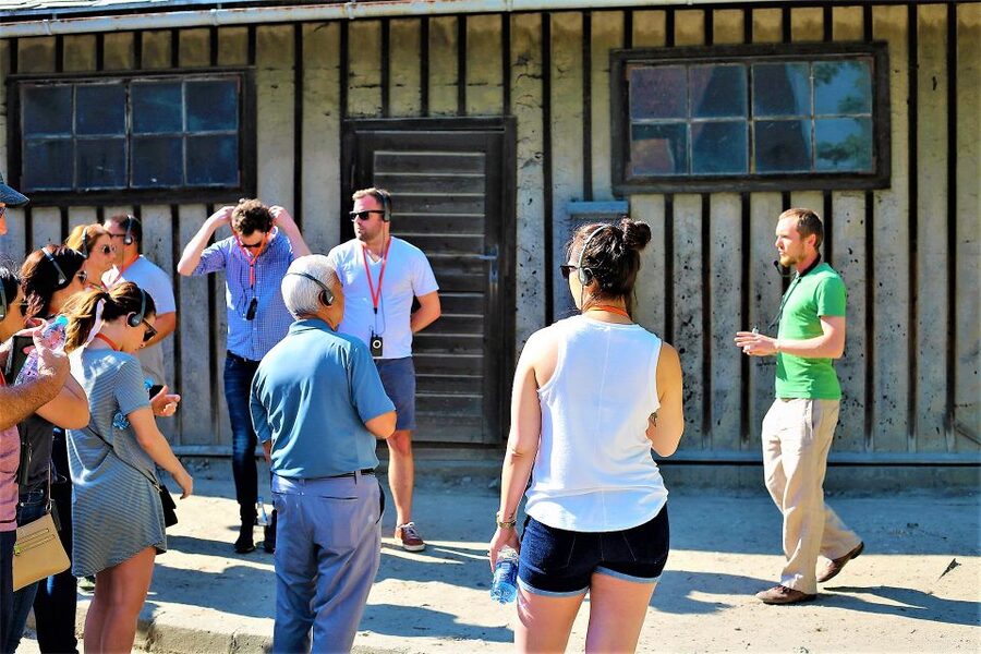 From Krakow: Auschwitz Birkenau Small Group Tour with Pickup - The museum handoff: hearing your guide and staying together